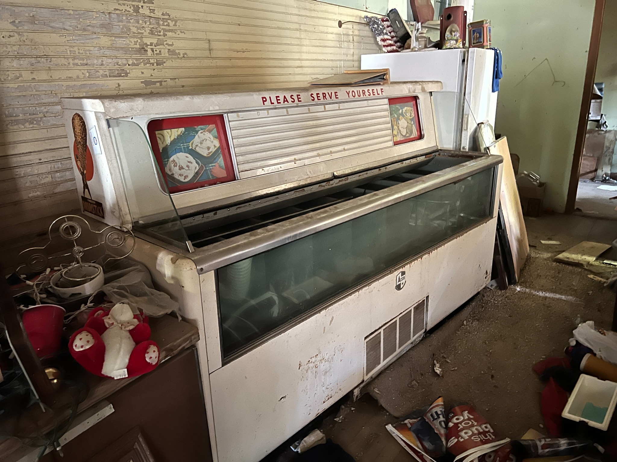 The old store freezer, its “Please Serve Yourself” lettering still visible.