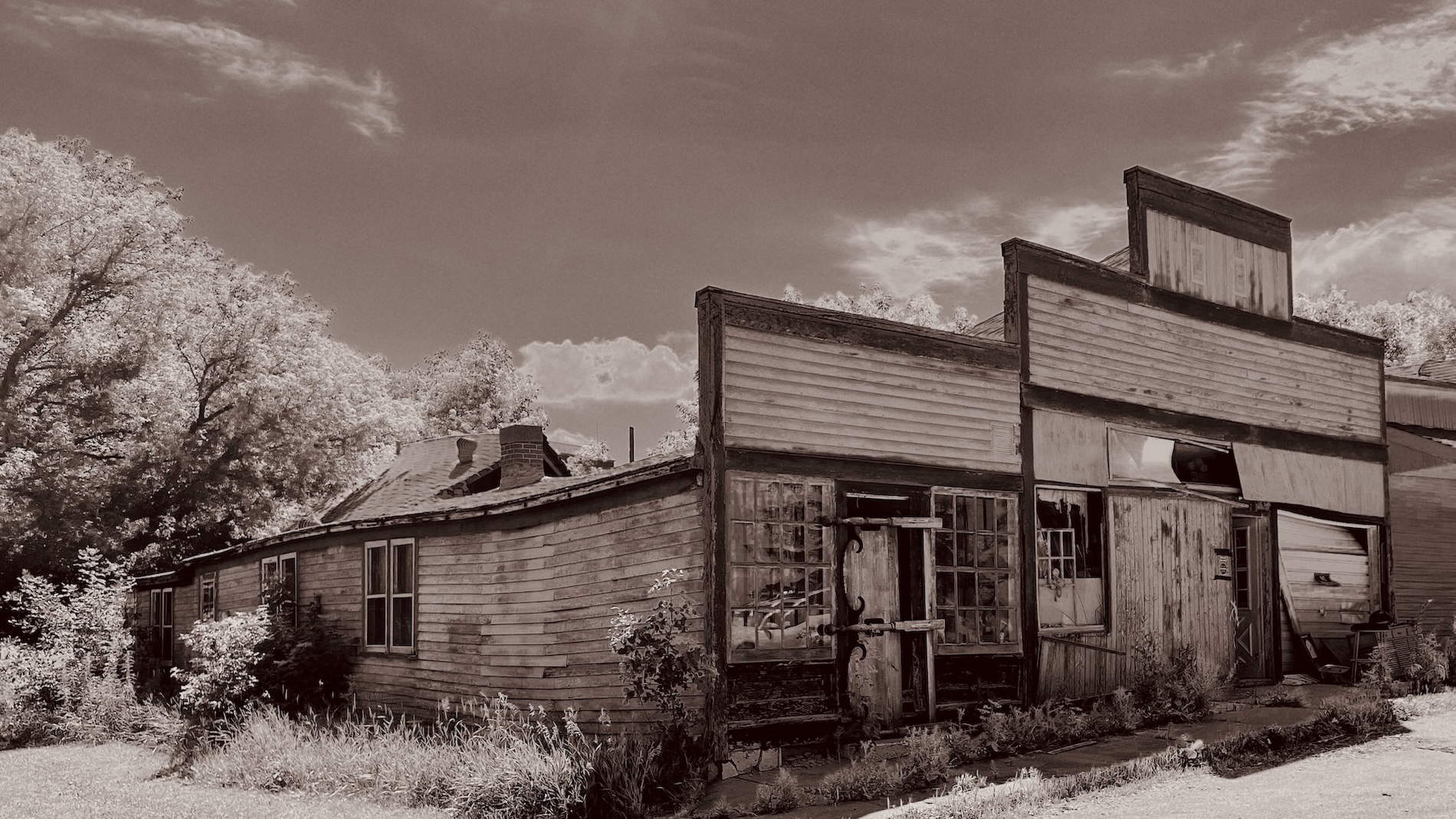 The weathered storefront and adjoining house.